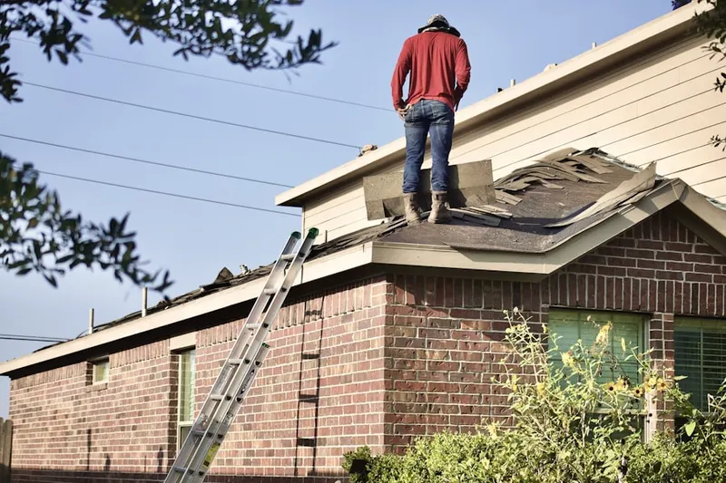 Professional roofer working on a residential roof in Florence Station